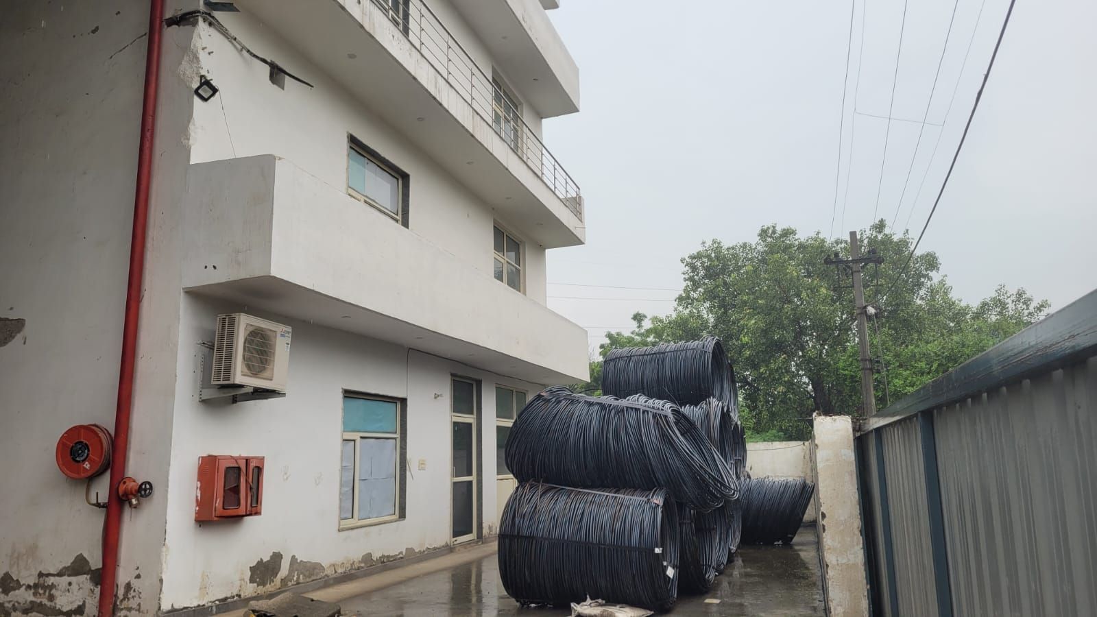 The office building at Plot 213, with wire rod coils stacked alongside